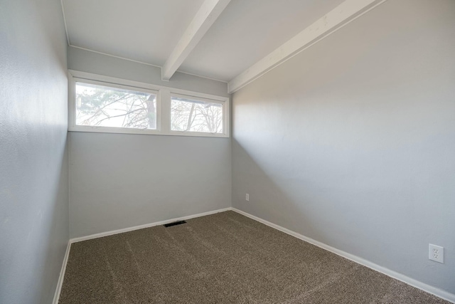 unfurnished room with baseboards, beamed ceiling, carpet floors, and visible vents