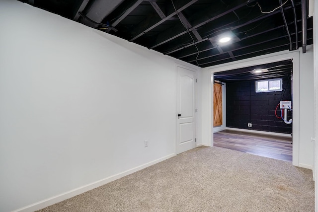 below grade area with carpet and baseboards