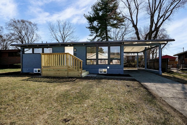 mid-century home with a carport, fence, a front yard, and driveway