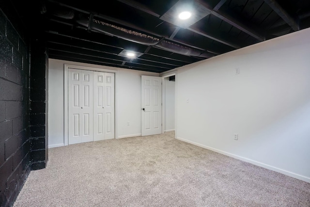 finished below grade area featuring baseboards and carpet floors