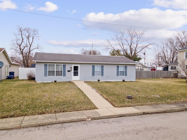 ranch-style house featuring a front lawn and fence