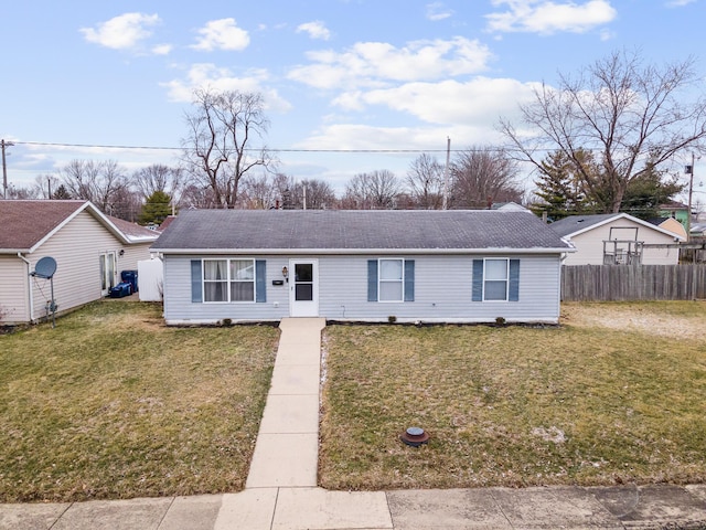 ranch-style home featuring a front lawn and fence