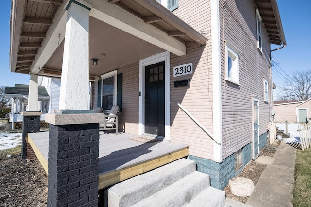 view of exterior entry featuring a porch