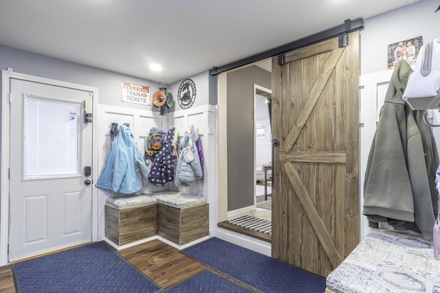 mudroom featuring hardwood / wood-style flooring and a barn door