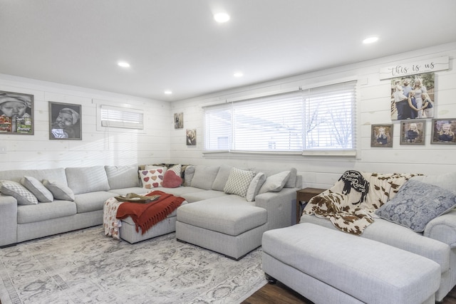 living room featuring hardwood / wood-style floors and wood walls