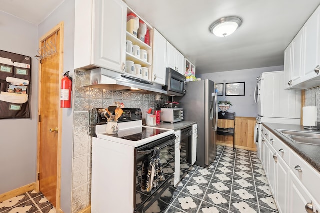 kitchen featuring tasteful backsplash, black microwave, under cabinet range hood, range with electric stovetop, and white cabinets