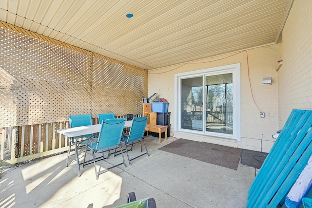 view of patio with outdoor dining space and fence