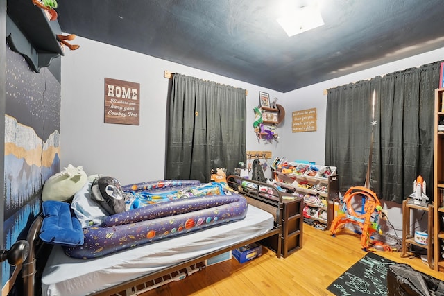 bedroom with wood finished floors