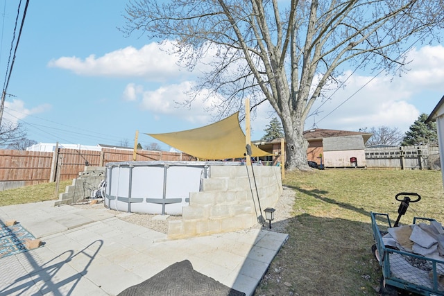 view of yard with an outdoor structure, a fenced in pool, and a fenced backyard