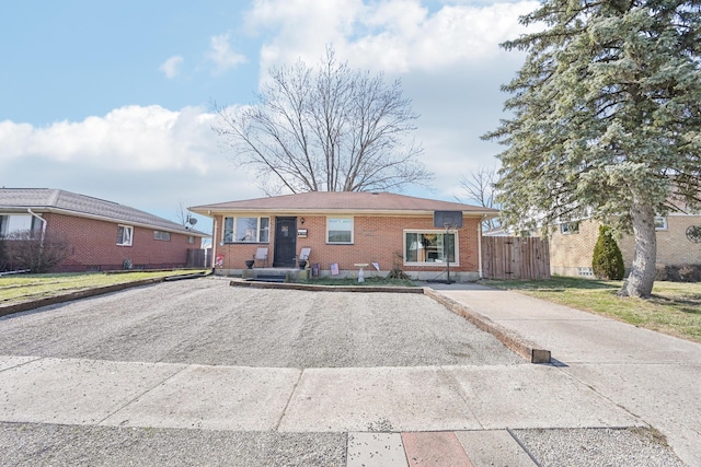 view of front of house with brick siding and fence