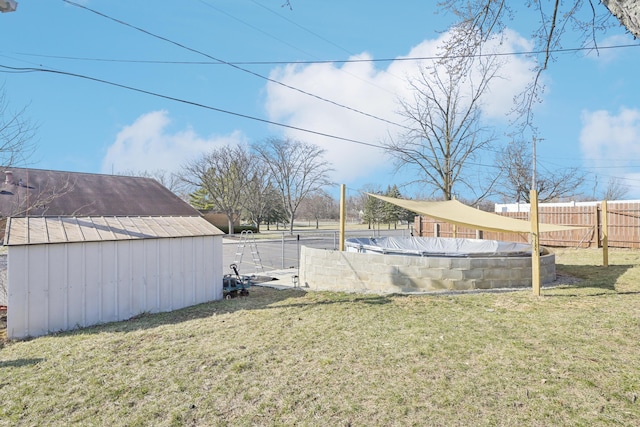 view of yard with an outbuilding, a shed, and fence