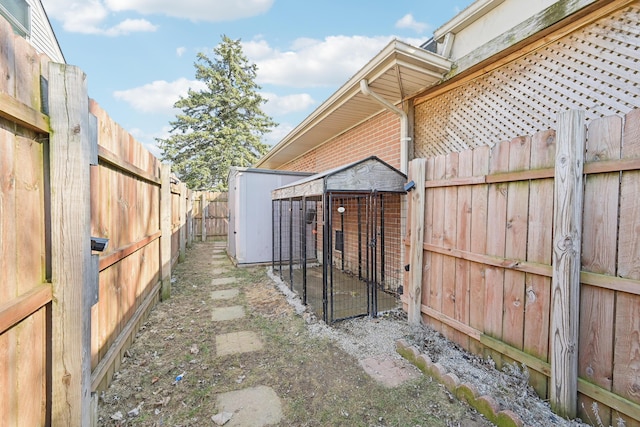 view of yard featuring an outdoor structure and a fenced backyard