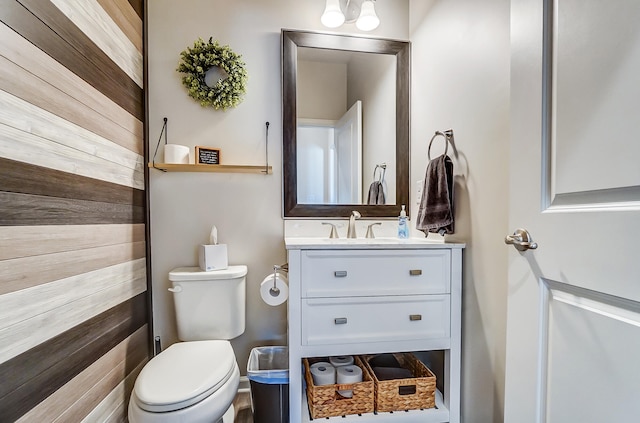 half bathroom with vanity and toilet