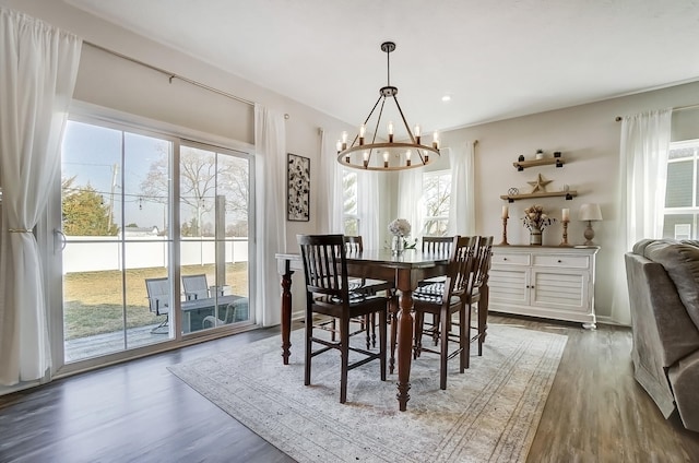 dining room with recessed lighting, a notable chandelier, and wood finished floors