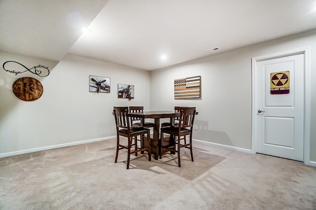 dining room featuring baseboards, carpet floors, and visible vents