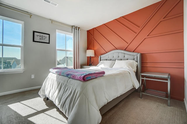 carpeted bedroom with visible vents and baseboards