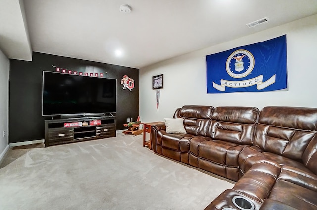 living area with visible vents, baseboards, and carpet