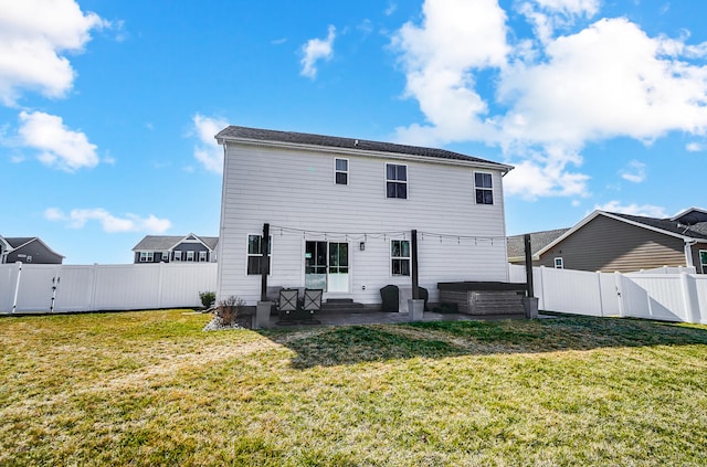 rear view of house with a fenced backyard, a patio, a yard, and a gate