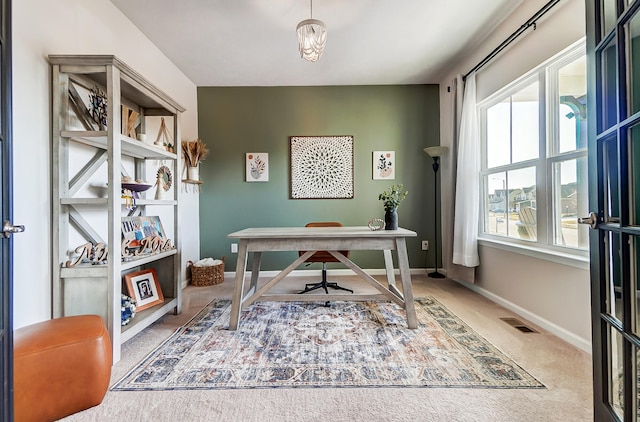 carpeted office with baseboards and visible vents