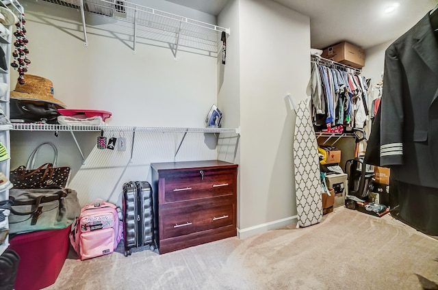 spacious closet with carpet