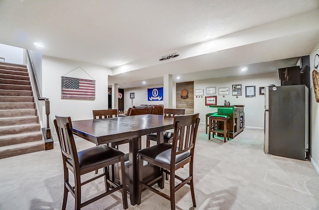 dining area with recessed lighting, baseboards, light carpet, and stairs