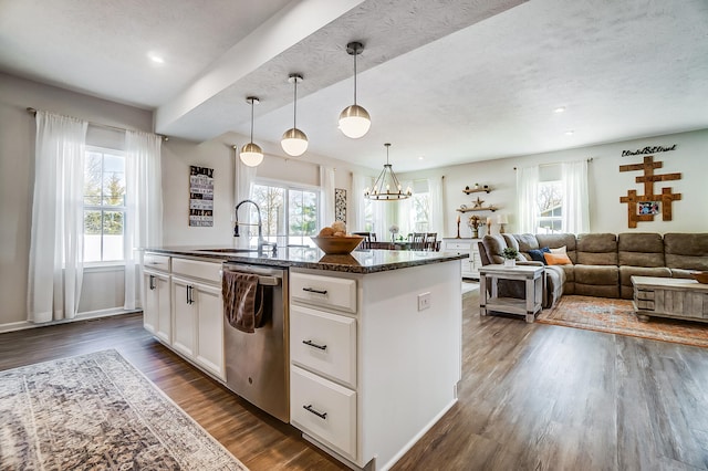 kitchen featuring a kitchen island with sink, dark wood-style flooring, a sink, white cabinets, and dishwasher