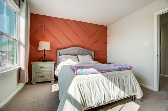 carpeted bedroom featuring baseboards