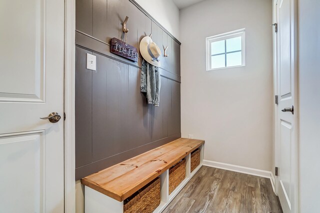 mudroom featuring wood finished floors and baseboards