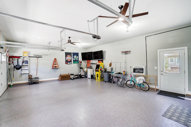 garage with ceiling fan, a garage door opener, and heating unit