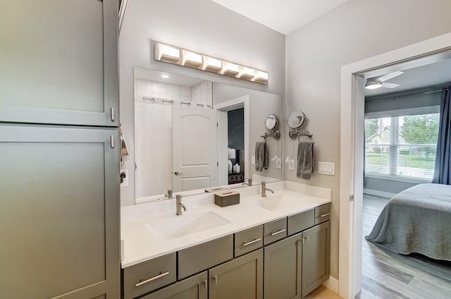 bathroom with hardwood / wood-style flooring, vanity, and ceiling fan