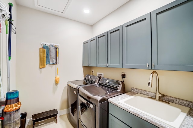 laundry room with cabinets, washing machine and dryer, sink, and light tile patterned flooring