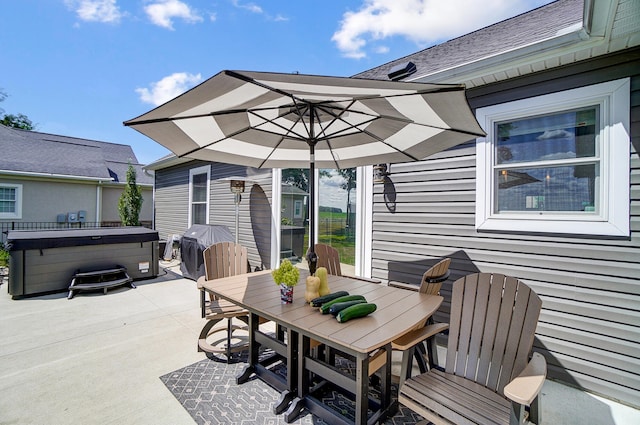 view of patio / terrace with a hot tub and area for grilling