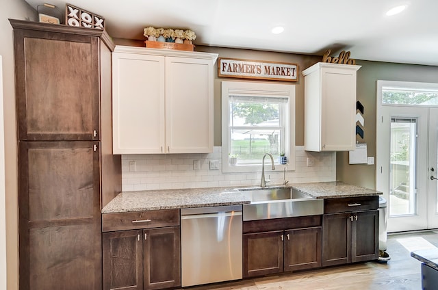 kitchen featuring white cabinets, dark brown cabinets, light stone countertops, and dishwasher