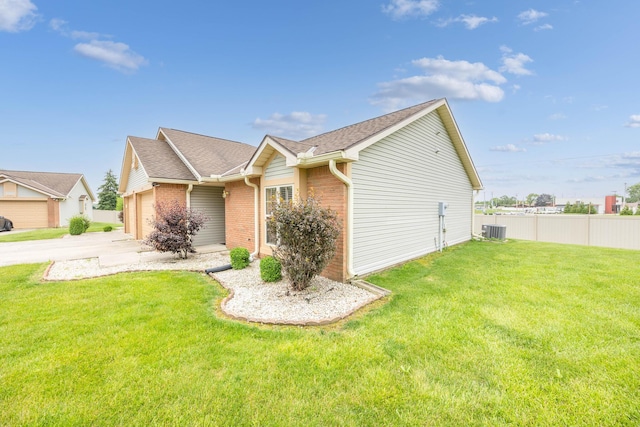 1534 Cross Pointe Cir, Bellefontaine, OH 43311 - view of property exterior featuring a garage, brick siding, concrete driveway, and a shingled roof