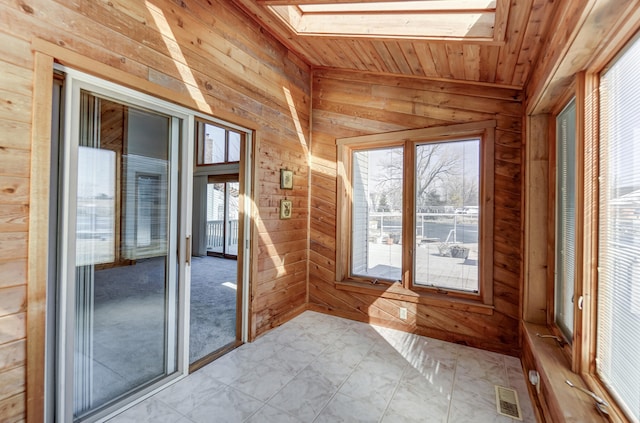 unfurnished sunroom with a skylight, wooden ceiling, and visible vents