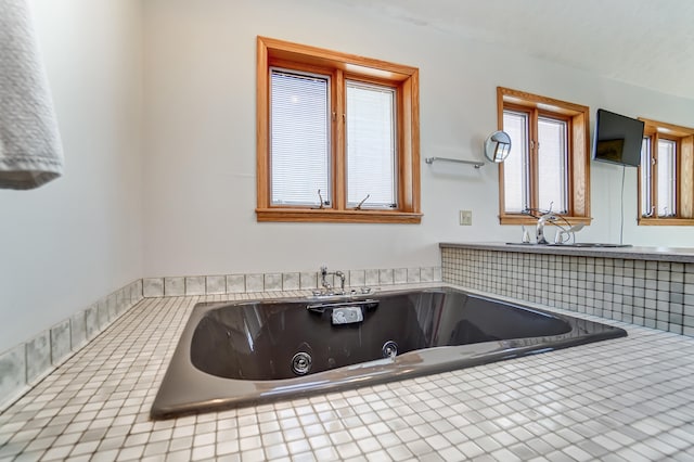 bathroom with a whirlpool tub and a sink