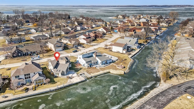 birds eye view of property with a water view and a residential view