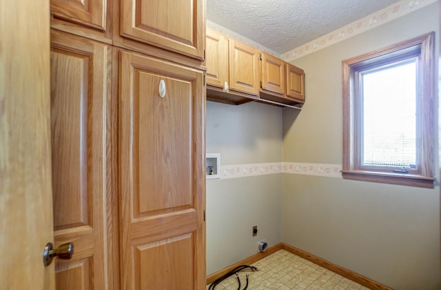 laundry area with a textured ceiling, washer hookup, baseboards, cabinet space, and electric dryer hookup