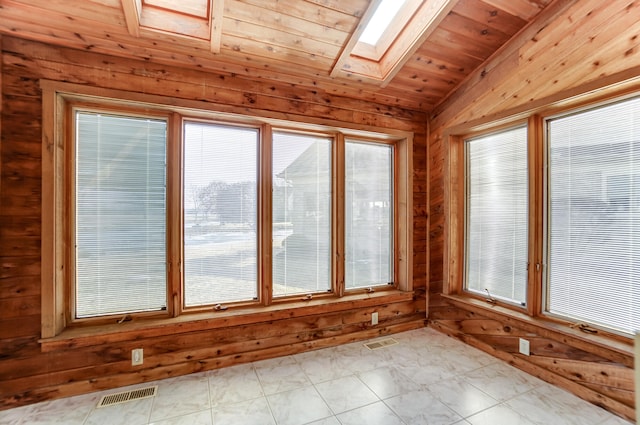 unfurnished sunroom featuring vaulted ceiling with skylight, wood ceiling, and visible vents