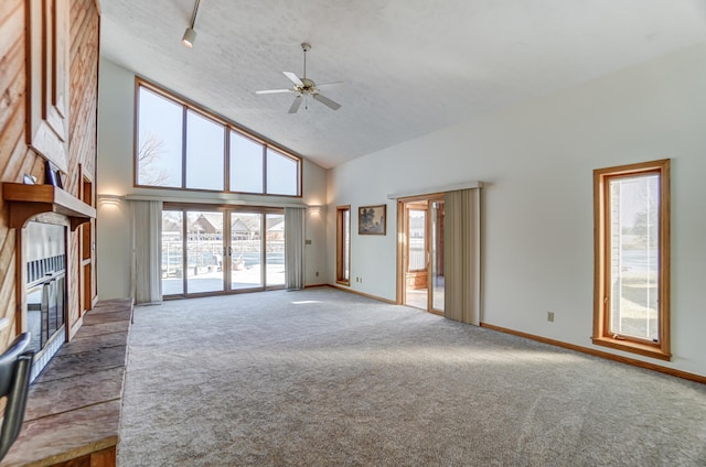 unfurnished living room with high vaulted ceiling, carpet, french doors, and baseboards