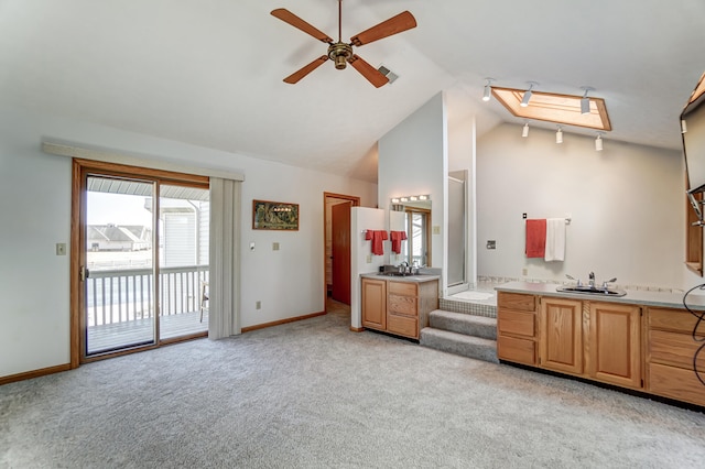 interior space with light carpet, ceiling fan, baseboards, and a sink