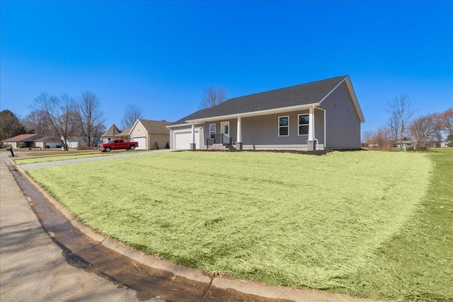 ranch-style home featuring a front yard, a garage, and driveway