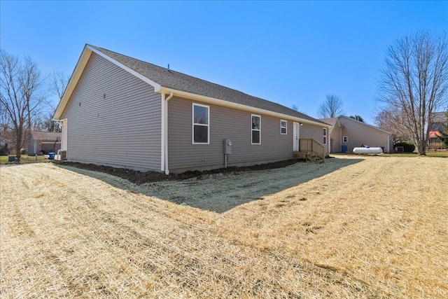 view of side of property with a lawn