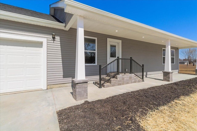 entrance to property featuring an attached garage