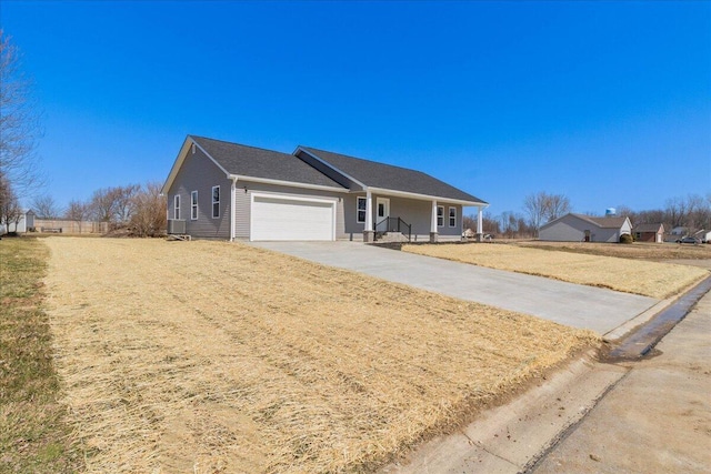 single story home featuring a front yard, central AC, a garage, and driveway