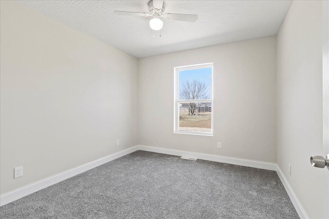 unfurnished room featuring visible vents, baseboards, ceiling fan, a textured ceiling, and dark carpet