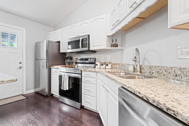 5175 Locust Post Ln, Columbus, OH 43230 - kitchen featuring appliances with stainless steel finishes, vaulted ceiling, white cabinetry, light stone counters, and dark wood-style flooring