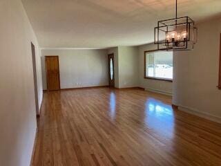 interior space with an inviting chandelier and wood-type flooring