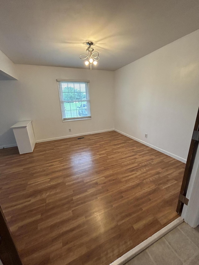 5151 Pheasant St, Lima, OH 45807 - unfurnished living room with wood finished floors and a chandelier
