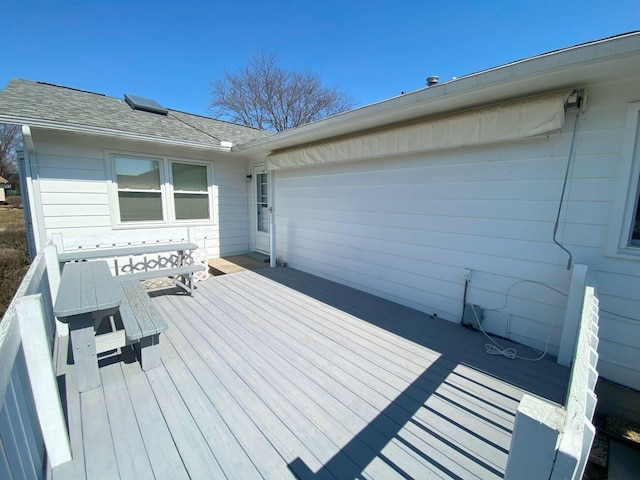 wooden terrace featuring an attached garage